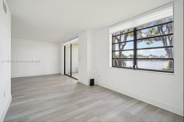 spare room with light hardwood / wood-style flooring