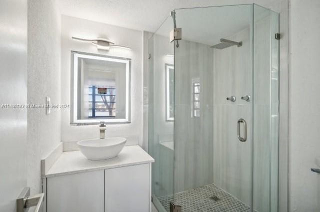 bathroom with vanity and walk in shower