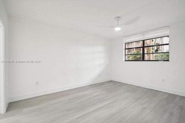 spare room featuring ceiling fan and light wood-type flooring