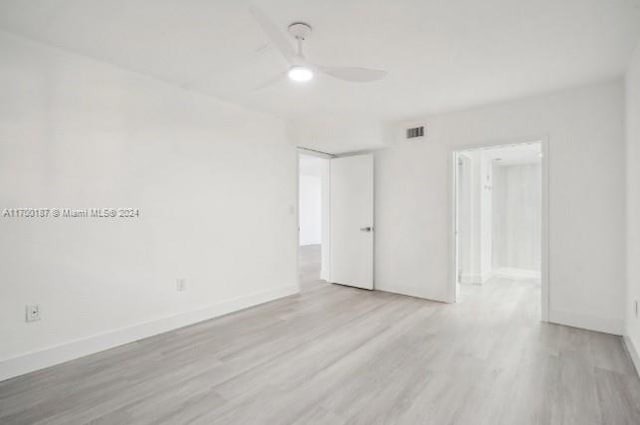 unfurnished room with ceiling fan and light hardwood / wood-style flooring