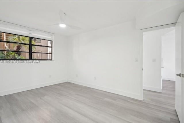 unfurnished room featuring light wood-type flooring and ceiling fan