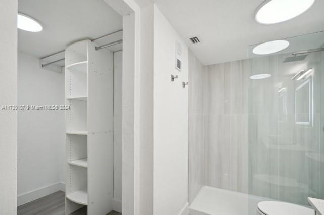 bathroom with vanity, toilet, and walk in shower