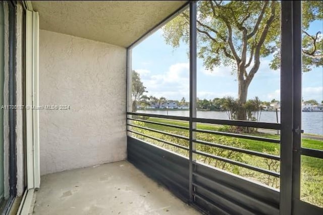 unfurnished sunroom with a water view