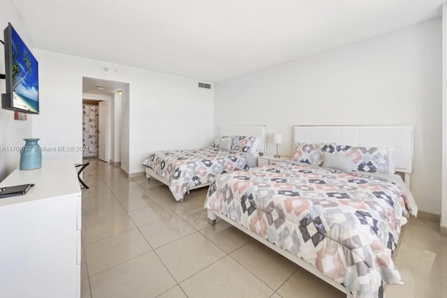 bedroom with light tile patterned flooring