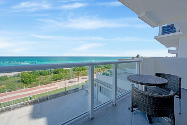 balcony with a view of the beach and a water view