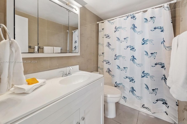 bathroom featuring curtained shower, tile patterned flooring, vanity, and toilet