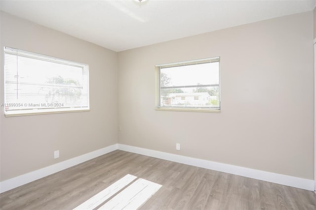 spare room with plenty of natural light and light wood-type flooring