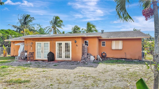 rear view of property featuring french doors