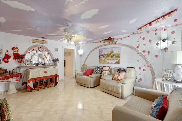 living room with ceiling fan and light tile patterned floors