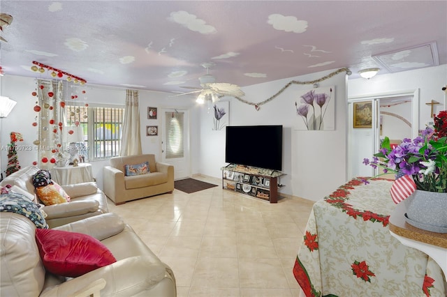 tiled living room with a textured ceiling and ceiling fan