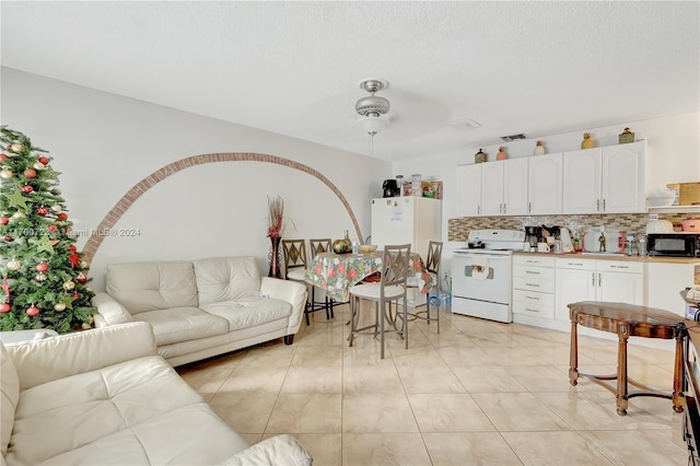 tiled living room with ceiling fan