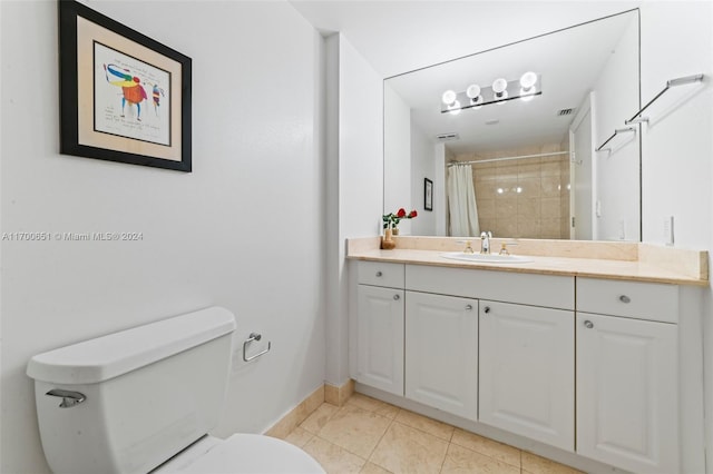 bathroom featuring a shower with curtain, tile patterned flooring, vanity, and toilet