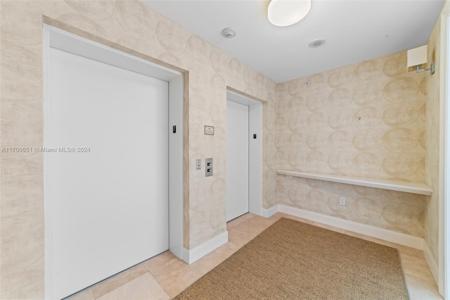 interior space featuring tile patterned flooring and elevator