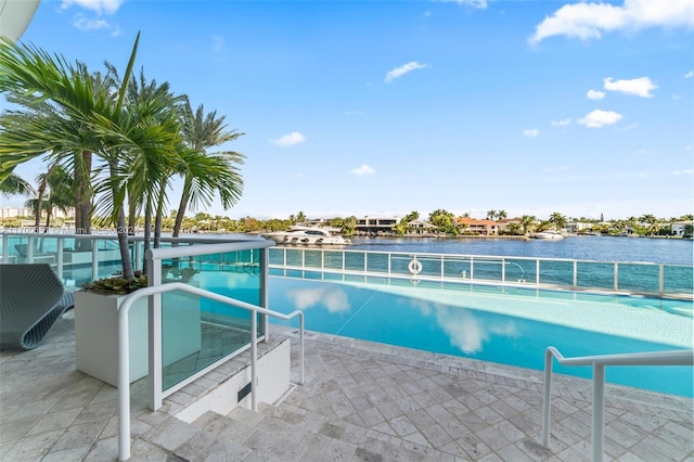 view of pool with a water view