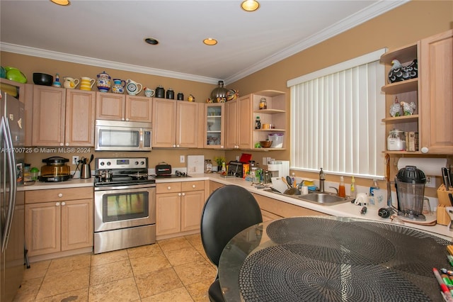 kitchen with appliances with stainless steel finishes, light brown cabinets, crown molding, and sink