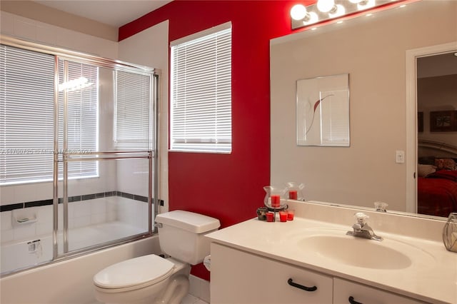 full bathroom featuring toilet, vanity, and combined bath / shower with glass door