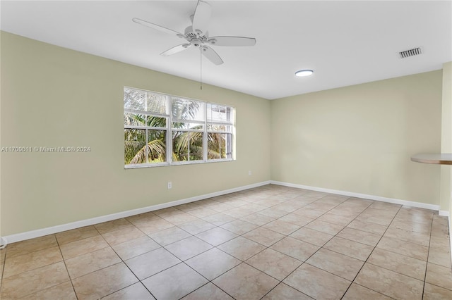 tiled spare room with ceiling fan