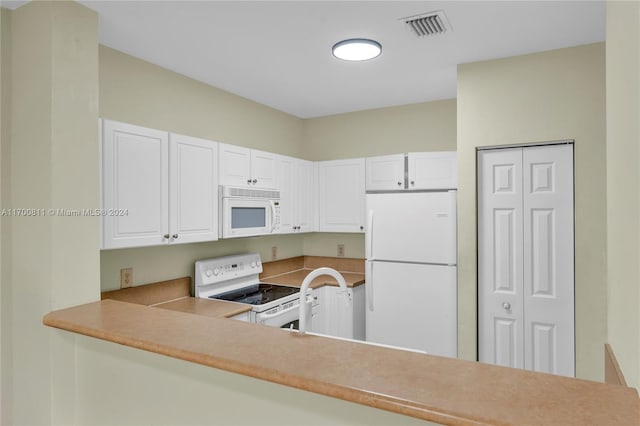 kitchen with white appliances and white cabinetry