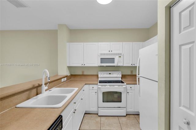 kitchen with white cabinetry, sink, light tile patterned flooring, and white appliances