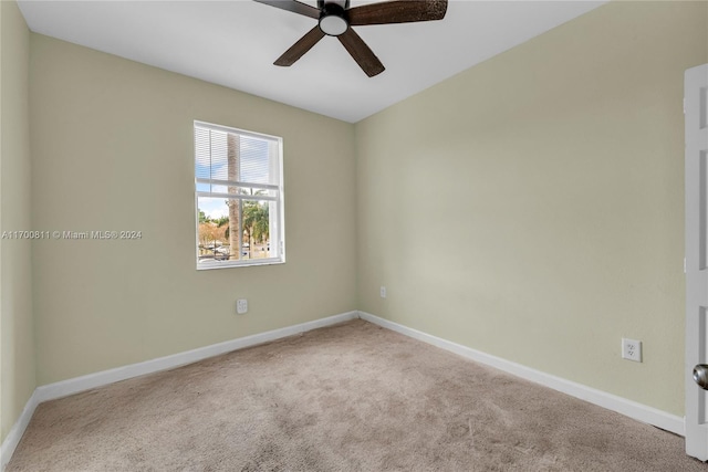 carpeted spare room with ceiling fan