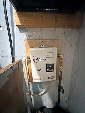 utility room featuring water heater