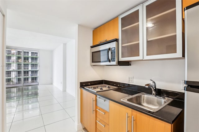 kitchen with sink, appliances with stainless steel finishes, and light tile patterned flooring