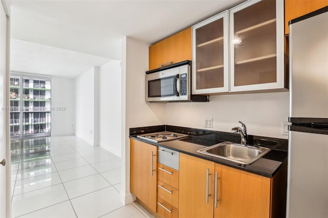 kitchen featuring sink, appliances with stainless steel finishes, and light tile patterned flooring