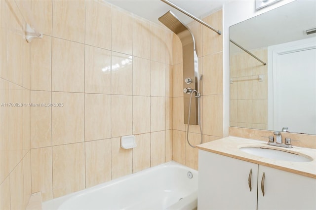 bathroom featuring tiled shower / bath combo and vanity