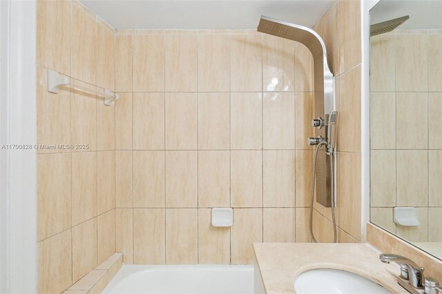 bathroom with vanity and tiled shower / bath