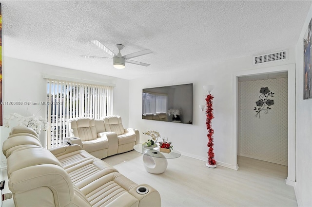 5236 NE 6th Ave Unit G25, Oakland Park, FL 33334 - living room with wood finished floors, ceiling fan, a textured ceiling, and baseboards
