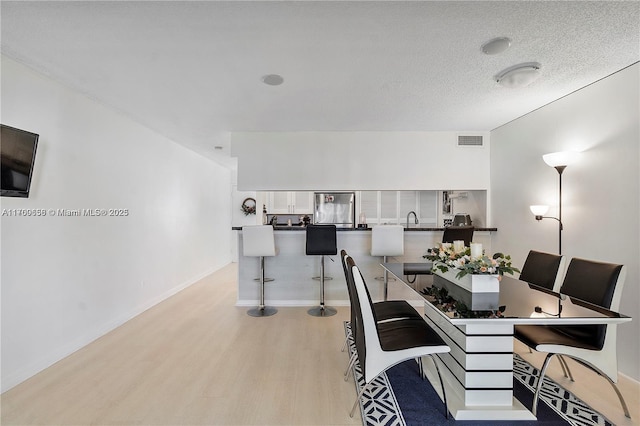 5236 NE 6th Ave Unit G25, Oakland Park, FL 33334 - dining room with light wood-type flooring and baseboards