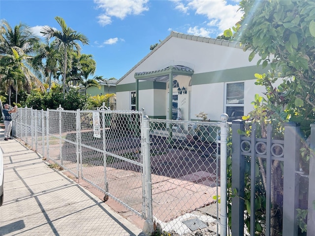 1428 SW 20th St, Miami, FL 33145 - view of front facade with a gate and stucco siding