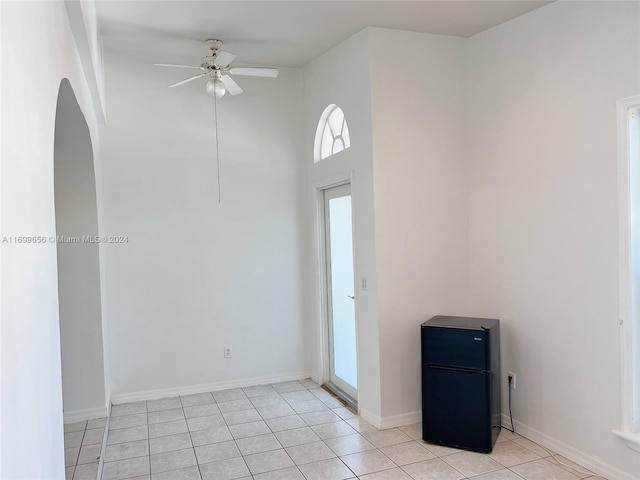 unfurnished room with ceiling fan and light tile patterned flooring