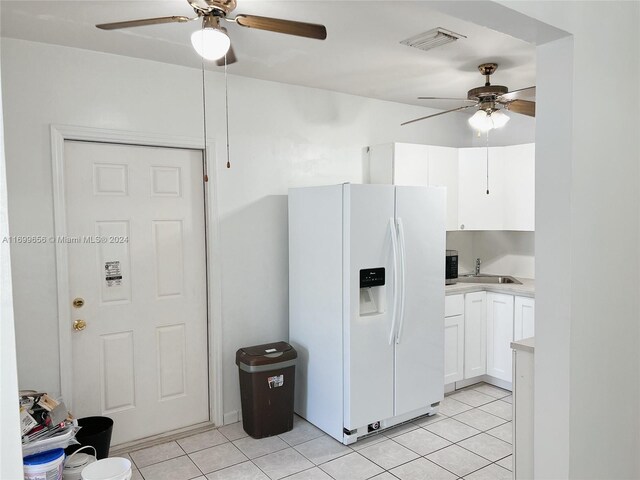 1428 SW 20th St, Miami, FL 33145 - kitchen featuring white refrigerator with ice dispenser, ceiling fan, light tile patterned flooring, light countertops, and white cabinets