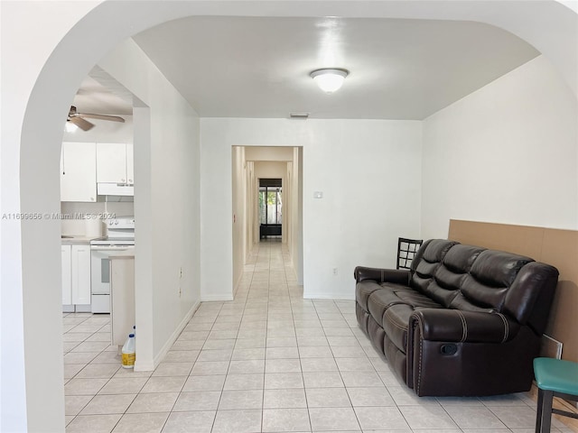 tiled living room with ceiling fan