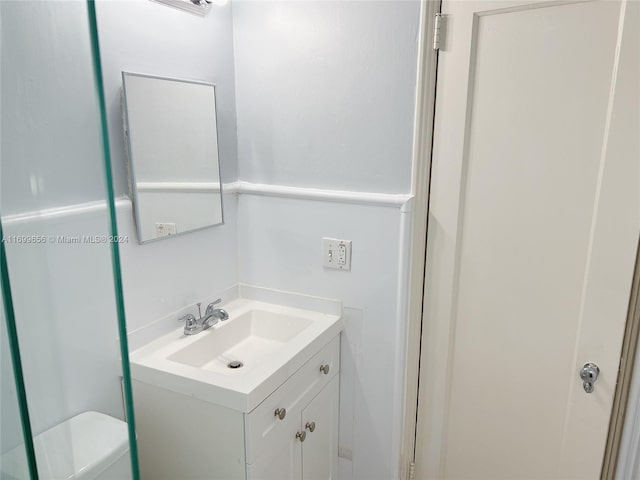 bathroom featuring vanity and toilet