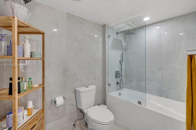 bathroom featuring toilet, tile walls, and bathtub / shower combination