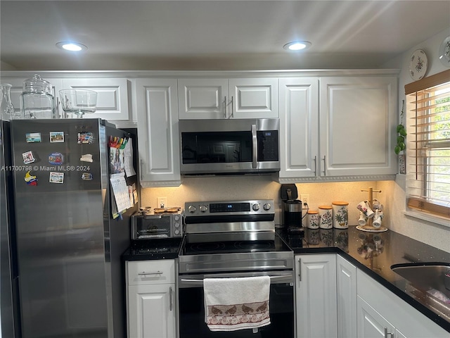 kitchen with white cabinets, appliances with stainless steel finishes, and sink