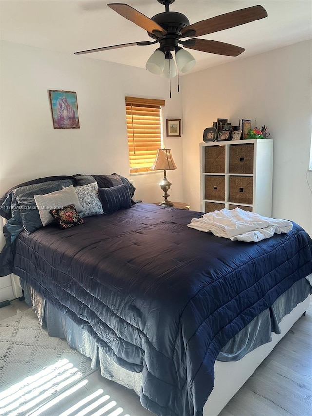 bedroom with ceiling fan and light hardwood / wood-style flooring