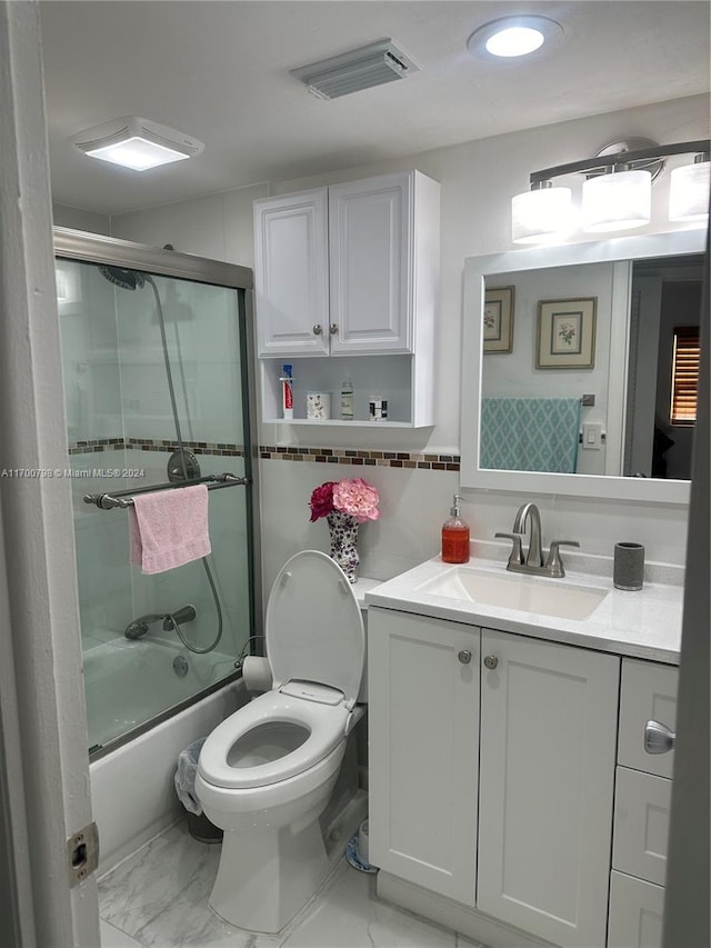 full bathroom with vanity, toilet, and enclosed tub / shower combo