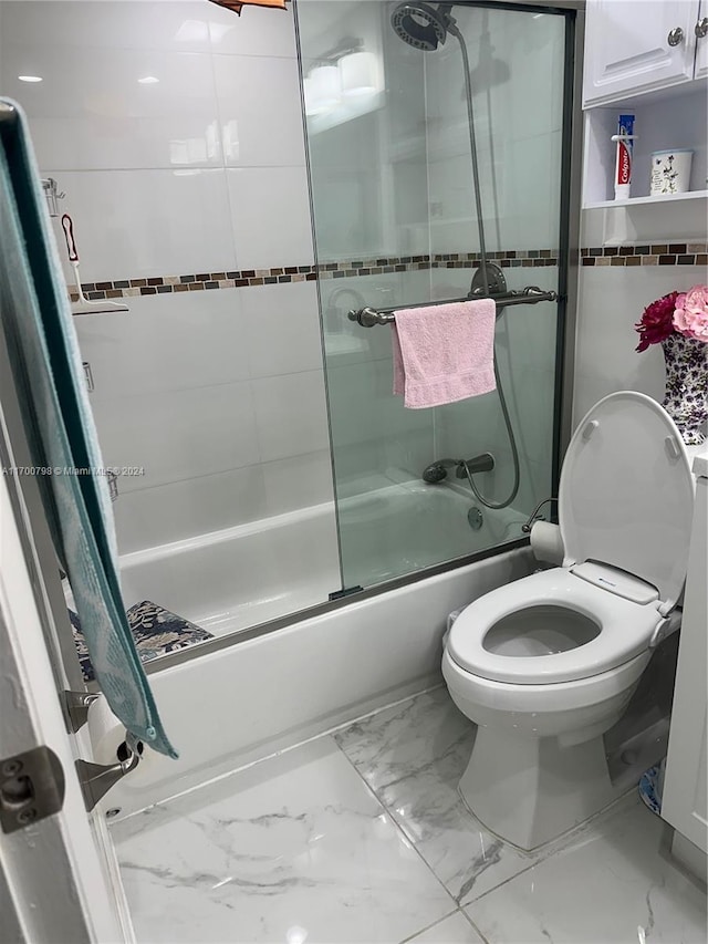 bathroom with toilet and enclosed tub / shower combo