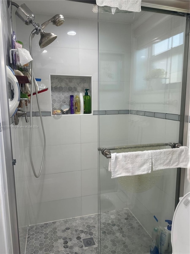 bathroom with a shower with shower door