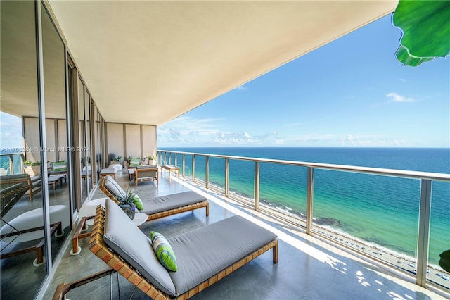 balcony with a water view and a beach view