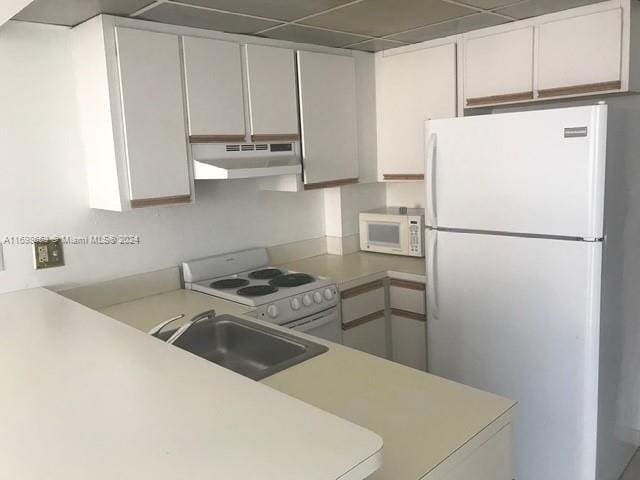 540 Brickell Key Dr Unit 830, Miami, FL 33131 - kitchen featuring white appliances, under cabinet range hood, light countertops, and white cabinetry