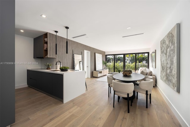 dining area featuring light hardwood / wood-style floors and sink