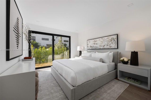 bedroom featuring hardwood / wood-style floors and access to outside