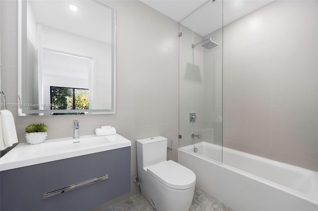 full bathroom with vanity, tiled shower / bath, and toilet