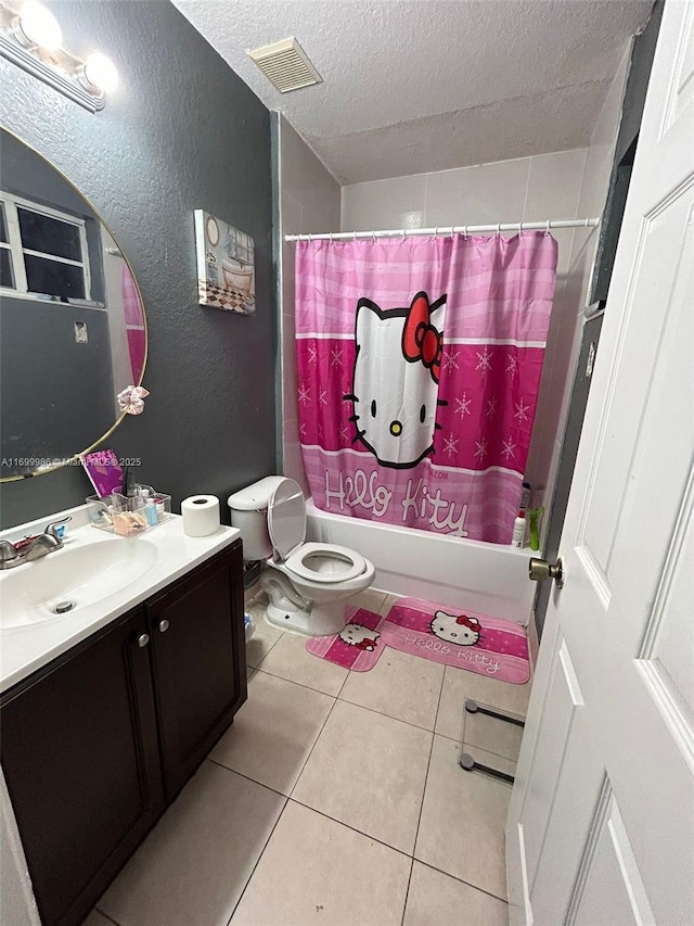 full bathroom with tile patterned flooring, a textured ceiling, toilet, shower / bath combo with shower curtain, and vanity