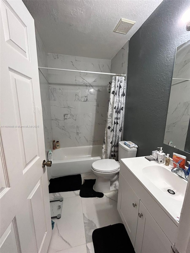 full bathroom with vanity, toilet, shower / bath combo with shower curtain, and a textured ceiling