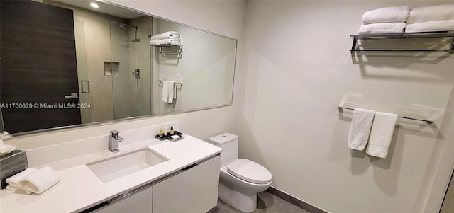 bathroom featuring tile patterned flooring, vanity, toilet, and walk in shower